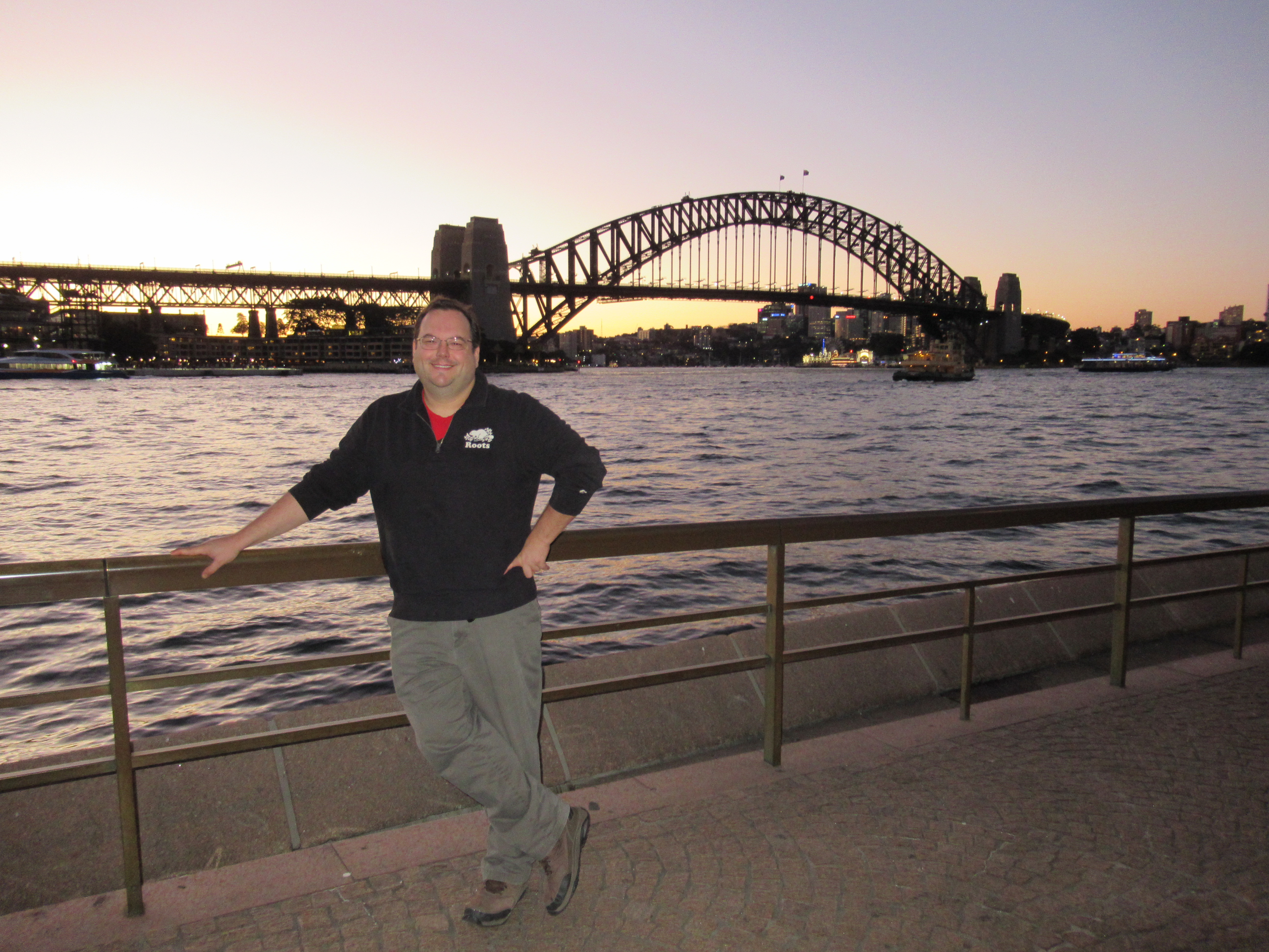 person in front of Bridge in Sydney harbor